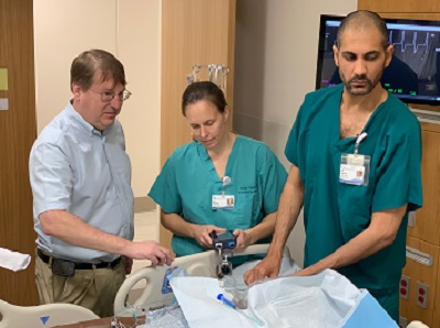 Three people practice an EM procedure